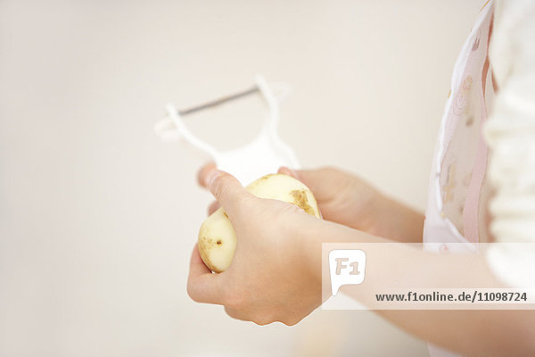 Girl peeling potato