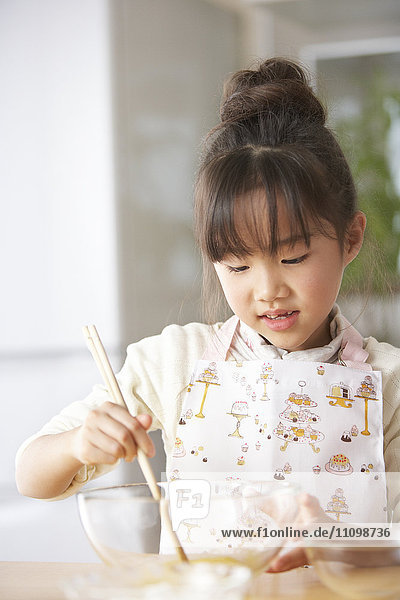Girl beating egg