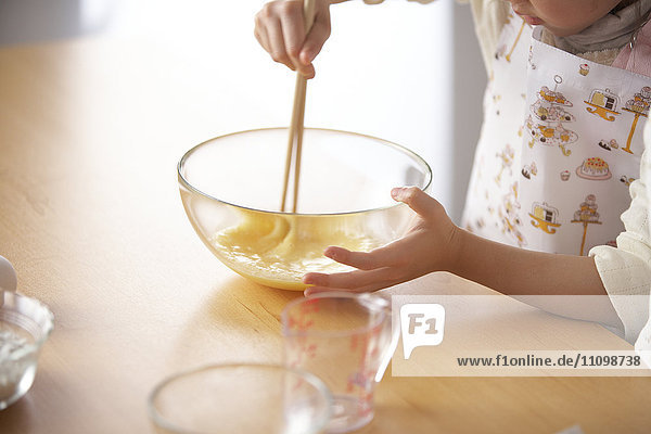 Girl beating egg