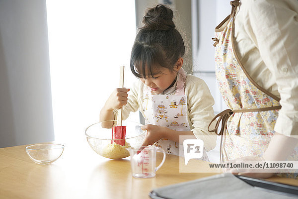 Mother and daughter cooking