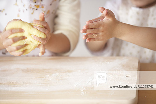 Girls kneading bread dough