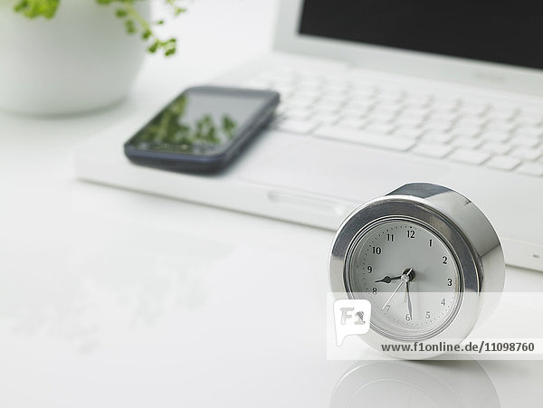 Laptop smart phone and clock