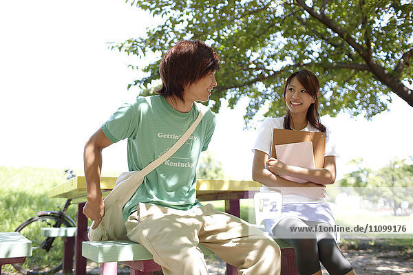 Two students sitting on a bench