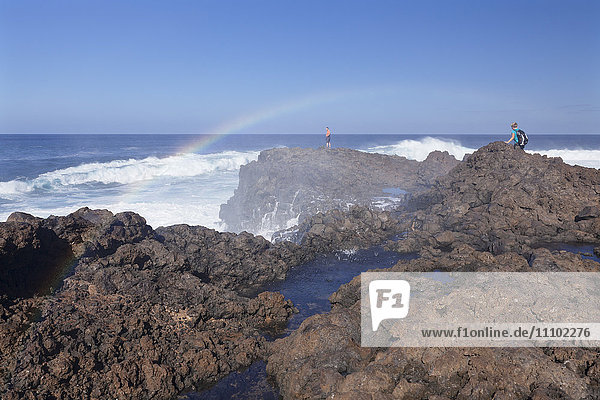 Tourists watching waves at the coast of La Fajana  Barlovento  Canary Islands  Spain  Atlantic  Europe