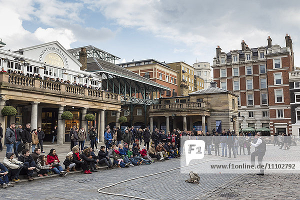 Jongleur tritt vor einer großen Menschenmenge auf  Piazza und Central Market  Covent Garden  London  England  Vereinigtes Königreich  Europa