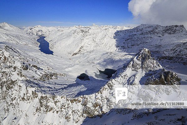 Aerial view of snowy Peak Peloso surrounded by Lago di Lei Val di Lei Chiavenna Spluga Valley Valtellina Lombardy Italy Europe