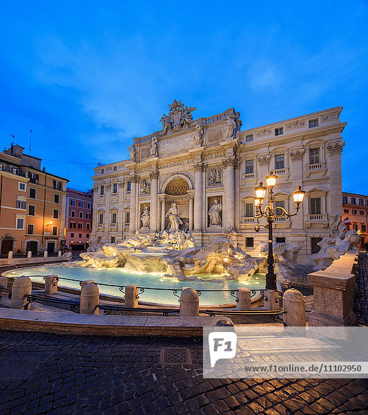 Panorama of Trevi Fountain illuminated by street lamps and the lights at dusk  Rome  Lazio  Italy  Europe