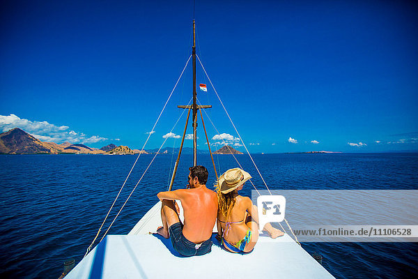 Couple relaxing on a Phinisi boat  Flores Island  Indonesia  Southeast Asia  Asia