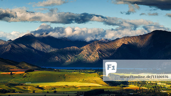 The plains and lakes of Otago region framed by cloud capped mountains  Otago  South Island  New Zealand  Pacific