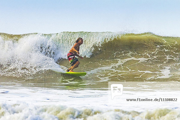 Middle-aged man surfing at this hip resort near Mal Pais  far south of Nicoya Peninsula  Santa Teresa  Puntarenas  Costa Rica  Central America