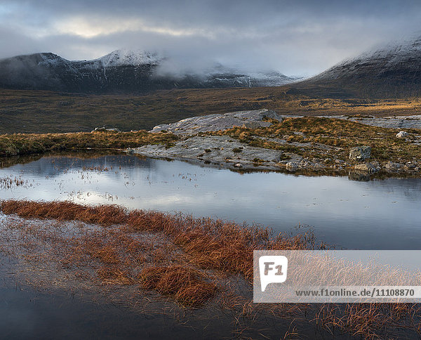 The mountain Quinag viewed across a lochan near Inchnadamph Sutherland Scotland United Kingom Europe