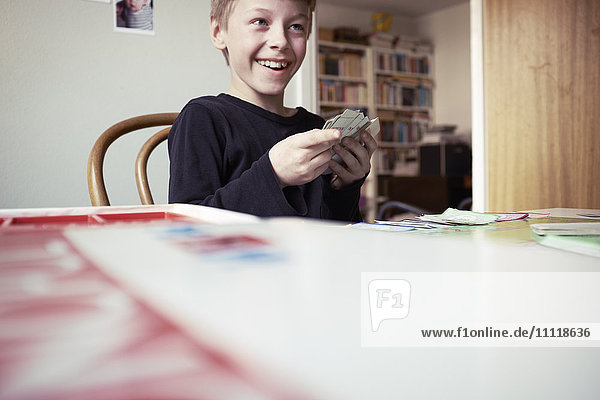 Smiling boy playing cards