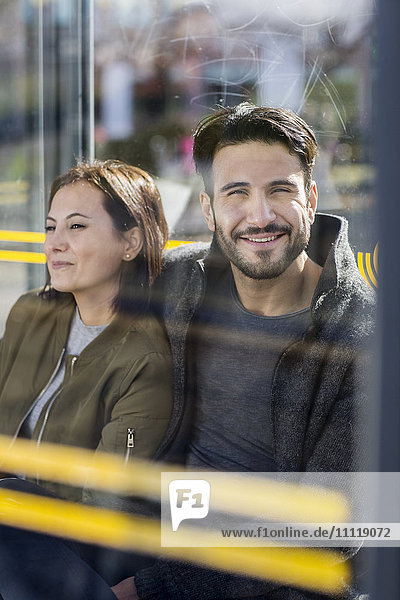 Mid adult couple on bus stop