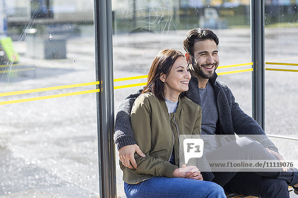 Mid adult couple on bus stop
