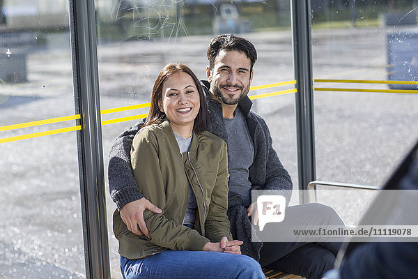 Couple waiting on bus stop