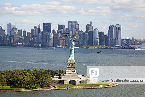 Statue of Liberty and city skyline  New York  New York  United States