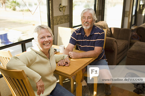 Senior Caucasian couple sitting in motor home