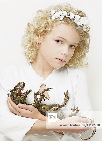 Girl cradling baby dinosaur