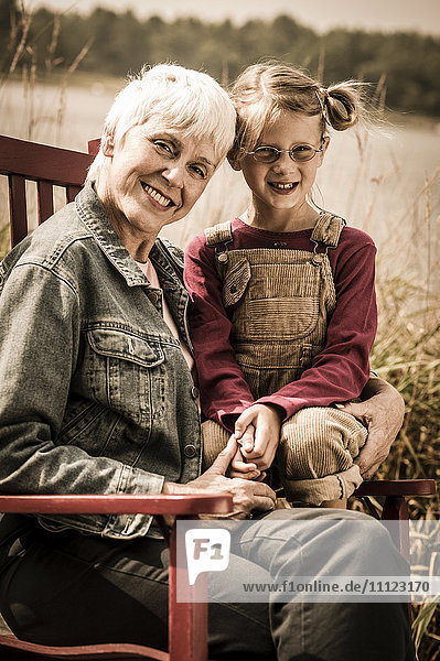 Older Caucasian woman smiling with granddaughter
