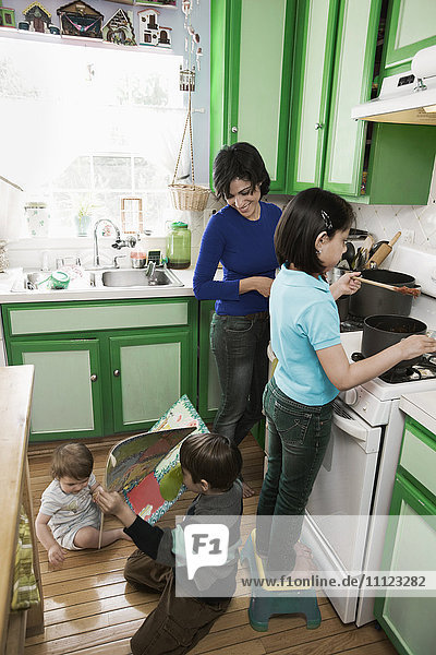 Hispanic mother and children in kitchen