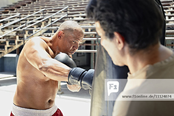 Hispanic boxer training in gym