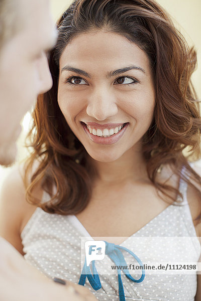 Hispanic woman smiling at boyfriend