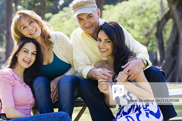 Hispanic family smiling outdoors
