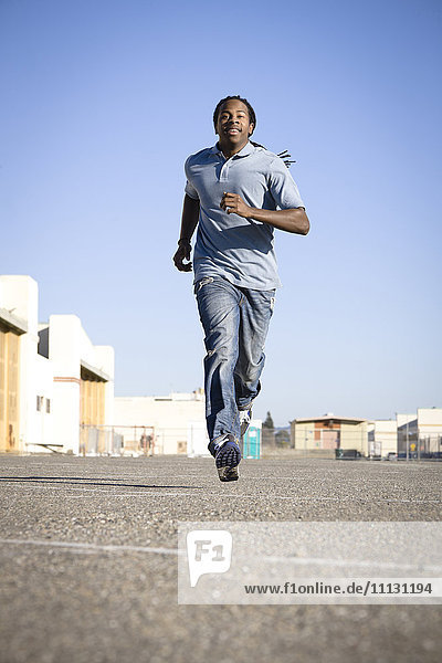 Black man running in parking lot