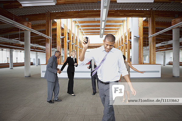Business people dancing in empty office space