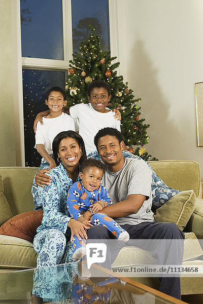African American family in pajamas at Christmas time