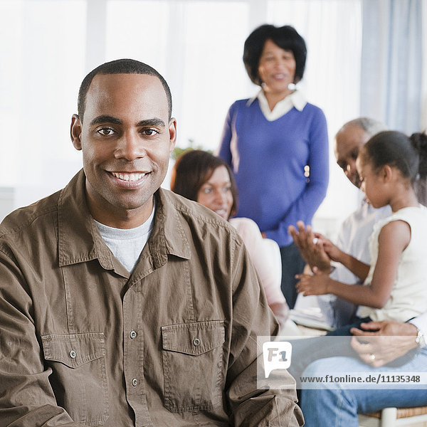 African American man in living room with family