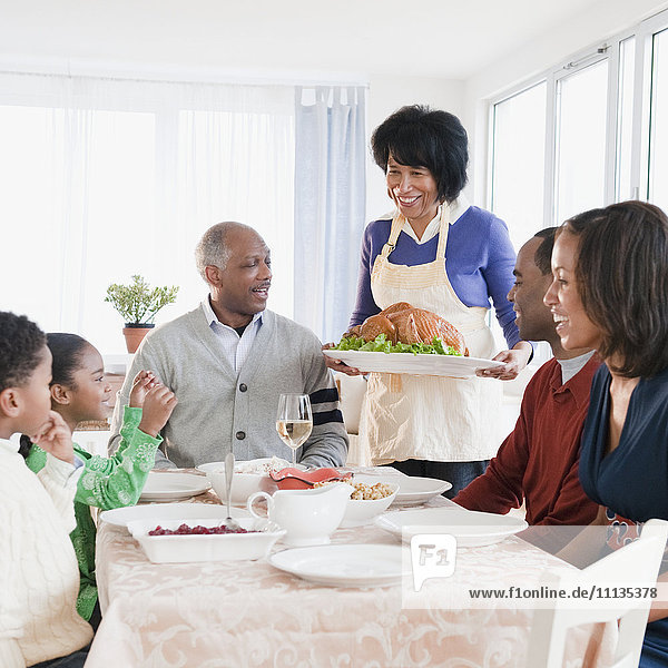 African American family about to enjoy Thanksgiving dinner