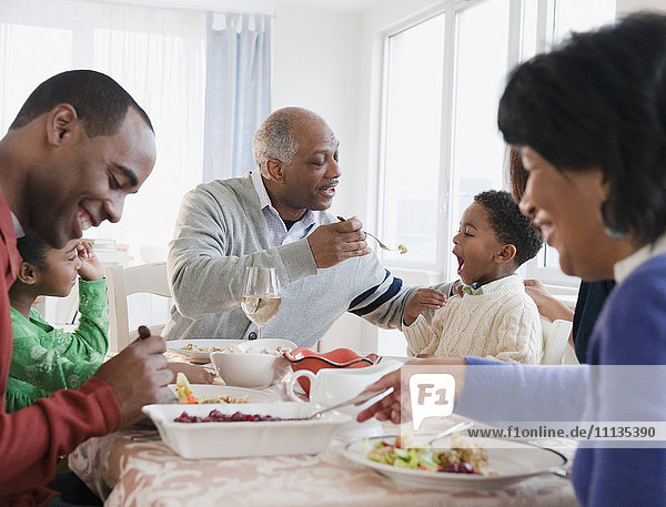 African American family enjoying Thanksgiving dinner