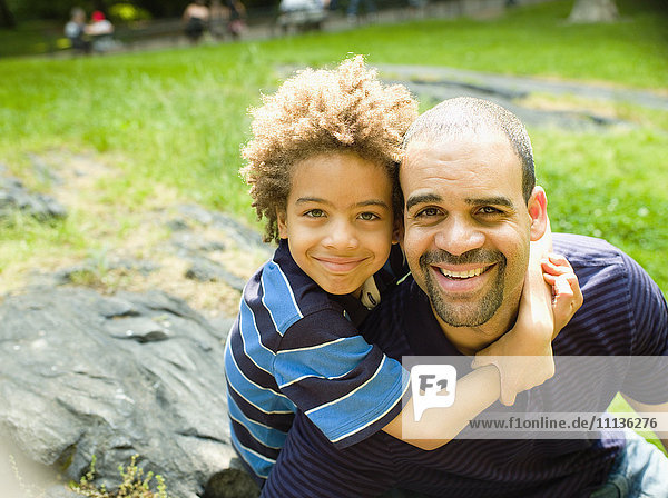 Boy hugging father outdoors
