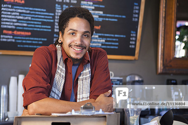 Mixed race man working in coffee shop