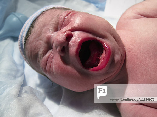 Crying Caucasian newborn baby boy