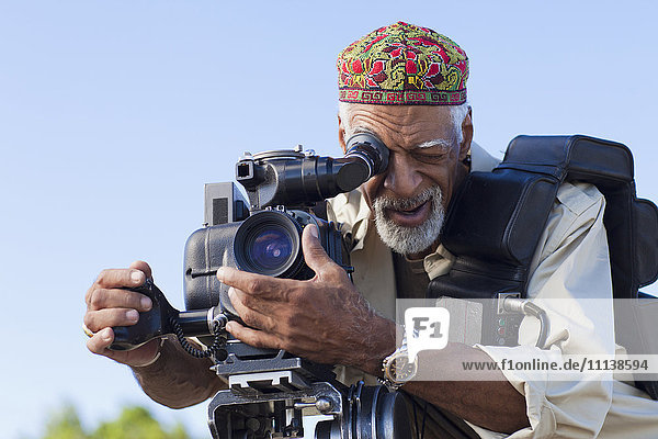 African American man using film camera