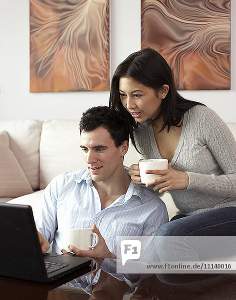 Couple looking at laptop together