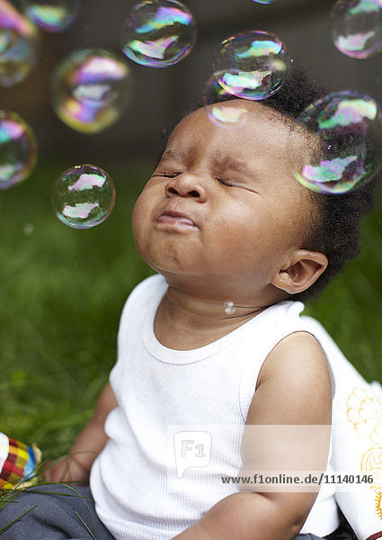 African American boy playing with bubbles