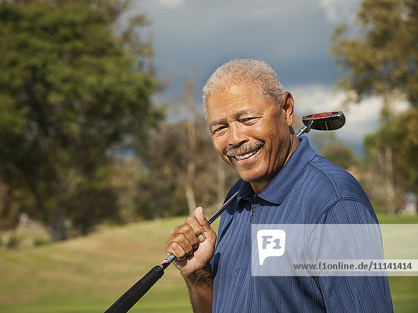 Black man playing golf