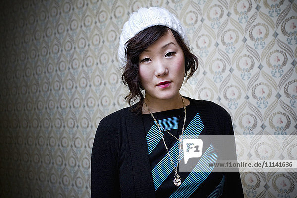 Serious Korean woman in knit cap