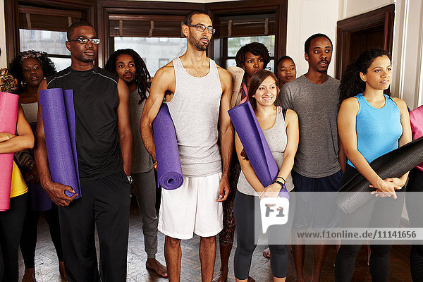 People holding yoga mats