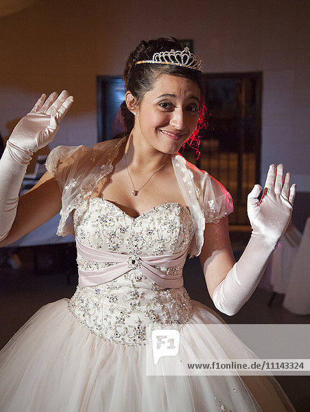 Teenage girl posing in quinceanera dress