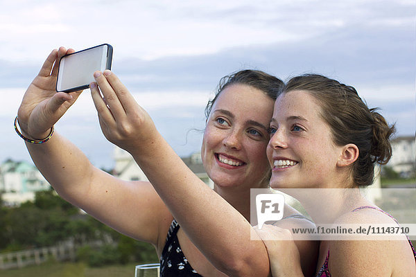 Caucasian women taking selfie with cell phone