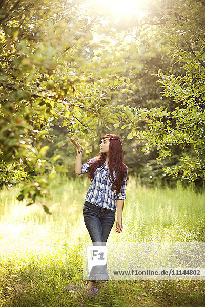 Girl admiring trees in rural field