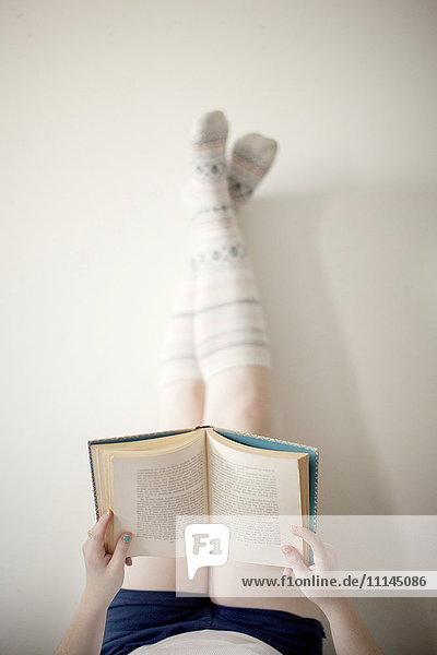 High angle view of woman reading book