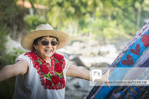 Hispanic woman smiling on beach