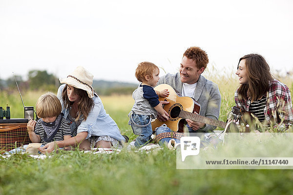 Family having picnic in rural field