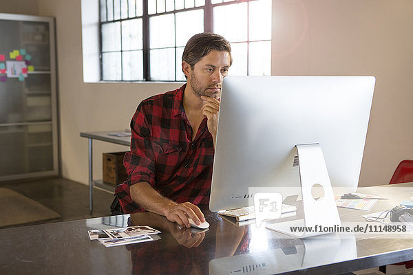 Caucasian businessman using computer in office