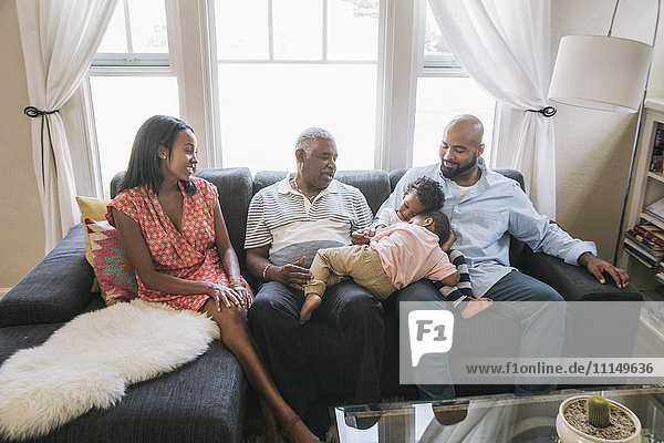 Afroamerikanische Familie entspannt sich auf dem Sofa
